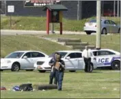  ?? JAMES CARBONE — NEWSDAY VIA AP ?? Suffolk County police work on the athletic field at Sachem High School East in Farmingvil­le, N.Y., where a teenage football player was fatally injured during a drill.