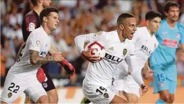  ?? PIC EPA ?? Valencia’s Rodrigo Moreno (centre) celebrates after scoring the equaliser against Atletico Madrid in their La Liga match on Monday.