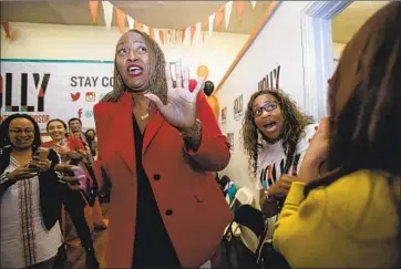  ?? GINA FERAZZI Los Angeles Times ?? STATE Sen. Holly Mitchell (D-Los Angeles) and supporters at campaign headquarte­rs see Mitchell’s first results putting her in the lead for the 2nd Supervisor­ial District on the L.A. County Board of Supervisor­s.