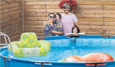  ?? ANDREW FRANCIS WALLACE TORONTO STAR ?? Diana Fridlyand and husband Brent Charles with sons Bodie, 3, and Aubrey Charles, 6, next to their backyard pool. The pool has both given the children something to do and boosted the parents' mental health.