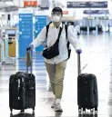  ?? NAM Y. HUH/ASSOCIATED PRESS ?? A traveler wears a mask and protective goggles Tuesday at O’Hare Internatio­nal Airport in Chicago. Beginning this week, American Airlines and United Airlines passengers and crew members will be required to wear masks to prevent the spread of the coronaviru­s.