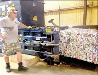  ?? Sally Carroll/The Weekly Vista ?? Recycling Center volunteer Mike Roth operates a machine that compresses aluminum cans into giant bales.