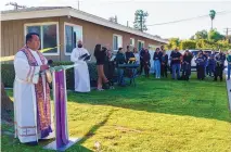  ?? DAMIAN DOVARGANES/ASSOCIATED PRESS ?? The Rev. Albert Avenido, left, and sacristan Hector Ibarra lead members of the Sacred Heart Catholic Church in Covina, Calif., on a prayer vigil for Bishop David O’Connell near his home on Sunday.