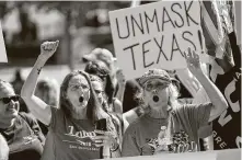  ??  ?? Two women who wanted to be identified only as patriots take part in the protest, which drew a few hundred people.