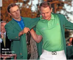  ??  ?? Nice fit Jordan Spieth hands over last year’s jacket.