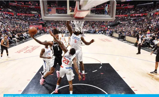  ??  ?? LOS ANGELES: Lonnie Walker IV #1 of the San Antonio Spurs drives to the basket against the LA Clippers at STAPLES Center in Los Angeles, California. — AFP