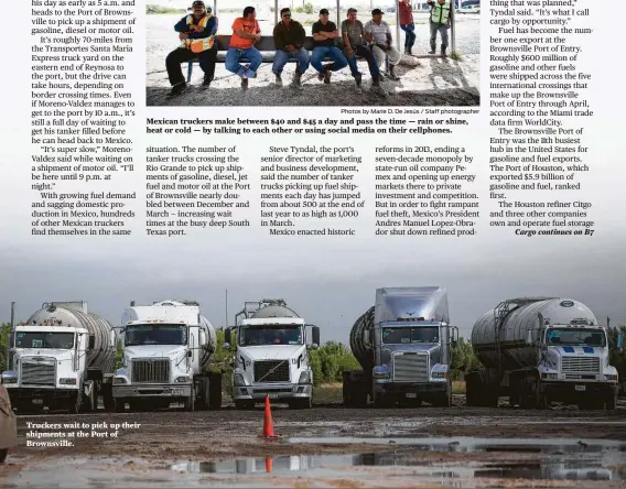  ?? Photos by Marie D. De Jesús / Staff photograph­er ?? Truckers wait to pick up their shipments at the Port of Brownsvill­e. Mexican truckers make between $40 and $45 a day and pass the time — rain or shine, heat or cold — by talking to each other or using social media on their cellphones.