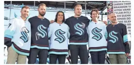  ?? KAREN DUCEY/GETTY IMAGES ?? Seattle Kraken expansion draft picks Jordan Eberle, Chris Driedger, Brandon Tanev, Jamie Oleksiak, Haydn Fleury and Mark Giordano during Wednesday’s expansion draft at Gas Works Park.