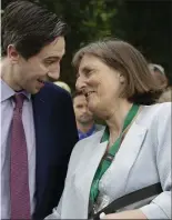  ??  ?? Simon Harris greets his former school Catherine Coveney, who is retiring.