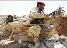  ?? JON GAMBRELL / ASSOCIATED PRESS ?? A Yemeni soldier allied to the country’s internatio­nally recognized government unslings his machine gun in February on the outskirts of Sanaa, Yemen.