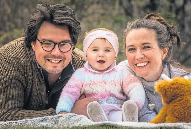  ??  ?? SURROGATE JOY: Sam and Olivia Rowlands at home with 10-month-old daughter Monica. Picture by Mhairi Edwards.