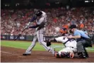  ?? Photograph: Carmen Mandato/Getty Images ?? Atlanta first baseman Freddie Freeman hits a solo home run during the sixth inning of Tuesday night’s Game 6 of the World Series at Houston’s Minute Maid Park.