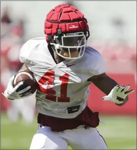  ?? (NWA Democrat-Gazette/Charlie Kaijo) ?? Running back T.J. Hammonds is back for a bonus senior season after starting last season as a slot receiver before taking 14 carries for 101 yards in spot duty after Rakeem Boyd opted out.