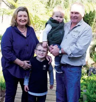  ??  ?? Karen and Peter Stoll relaxing at home in Warragul with their grandchild­ren Jack and Jimmy Stoll.