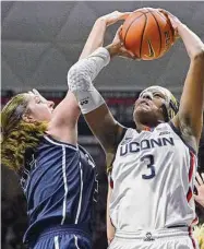  ?? Jessica Hill / Associated Press ?? UConn’s Aaliyah Edwards, right, is fouled by Butler’s Sydney Jaynes in the first half Saturday in Storrs.