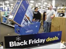  ?? CHARLIE RIEDEL / ASSOCIATED PRESS ?? People wait in line to buy television­s as they shop during an early Black Friday sale at a Best Buy store in Overland Park, Kan., on Thanksgivi­ng Day.