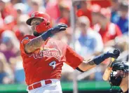  ?? JOHN BAZEMORE/ASSOCIATED PRESS ?? St. Louis catcher Yadier Molina is shown in a spring training game wearing the C-Flap extension to his helmet, which curves around to protect the cheek and jaw.