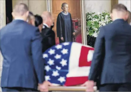  ?? Andrew Harnik / AP Pool ?? The flag-draped casket of Justice Ruth Bader Ginsburg, carried by Supreme Court police officers, arrives in the Great Hall at the Supreme Court in Washington on Wednesday. Ginsburg said she was “proud of being a Jew,” and noted the demand for justice, peace, and enlightenm­ent that “runs through the entirety of Jewish history.”