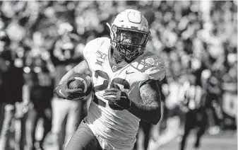  ?? Ron Jenkins / Associated Press ?? Baylor linebacker Terrel Bernard (26) returns an intercepti­on against TCU during the second half of a game Saturday in Fort Worth. Baylor won 29-23 in triple overtime.