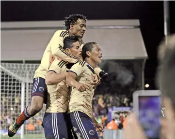  ?? — AFP photo ?? Colombia’s striker Carlos Bacca (R) celebrates scoring their first goal with teammates during the friendly internatio­nal football match between United States and Colombia at Craven Cottage in London on November 14, 2014.