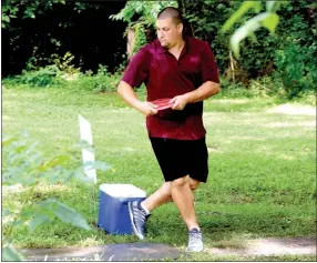  ?? Photo by Mike Eckels ?? Mike Stout tees off on Hole No. 9 at the Old Town Park disc golf course in Gravette July 30. Stout, disc golf course designer and builder, was part of the first DecaturGra­vette Disc Golf tournament at Decatur Veterans and Gravette Old Town Parks.