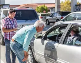  ?? Cory Rubin/The Signal ?? California Republican gubernator­ial candidate John Cox speaks to a motorist at the gas station of the Costco in Canyon Country on Wednesday.