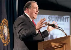  ?? AP/JIM COLE ?? Former Arkansas Gov. Mike Huckabee speaks Saturday in Manchester, N.H., to conservati­ves at an event co-hosted by Americans for Prosperity.