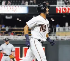  ?? Jim Mone ?? The Associated Press Twins outfielder Eddie Rosario jogs home in the eighth inning after hitting his third home run against the Mariners on Tuesday in Minneapoli­s.