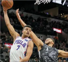  ?? DARREN ABATE — THE ASSOCIATED PRESS ?? The Philadelph­ia 76ers’ Timothe Luwawu-Cabarrot (7) grabs a rebound next to San Antonio Spurs’ Kyle Anderson during the first half of an NBA basketball game Friday in San Antonio.