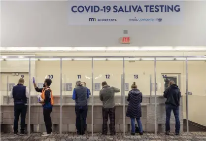  ?? Photograph: Elizabeth Flores/AP ?? People get tested at the new saliva Covid-19 testing site at the Minneapoli­s-St Paul internatio­nal airport.
