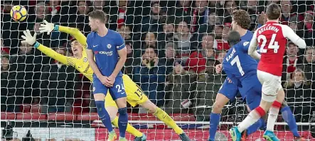  ?? — AP ?? Arsenal’s Hector Bellerin (right) scores against Chelsea in their English Premier League match at the Emirates Stadium in London on Wednesday. The match ended 2-2.