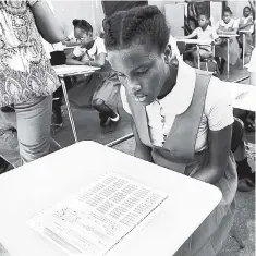  ?? FILE ?? Students pore over a GSAT paper at Hope Valley Experiment­al in Kingston on Thursday, March 22. GSAT will be replaced by the Primary Exit Profile in 2019.