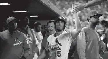  ?? CHRISTIAN GOODEN/TRIBUNE NEWS SERVICE ?? St. Louis Cardinals outfielder Randal Grichuk gets congratula­ted after scoring in the seventh inning against the Pittsburgh Pirates on Monday in St. Louis, Mo.