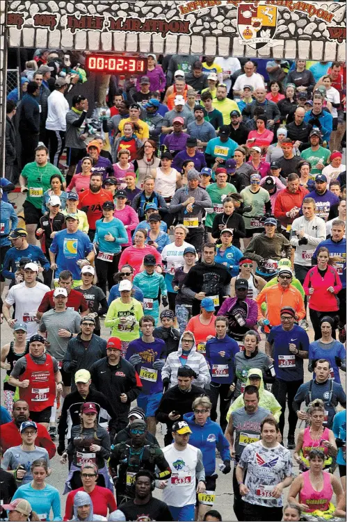  ?? Arkansas Democrat-Gazette/THOMAS METTHE ?? Runners take off Sunday morning at the start of the 2018 Little Rock Marathon. Drew Mueller won the men’s race, while Tia Stone was the women’s champion.