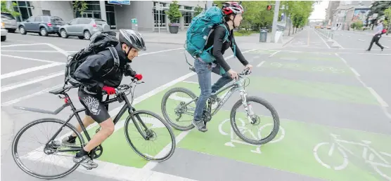  ?? LYLE ASPINALL ?? A fast-growing number of cyclists are getting around town by utilizing Calgary’s controvers­ial separated bike lanes, city officials say,