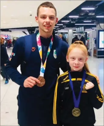  ??  ?? Lily Sheeran (12), from Tenure, won gold at the Karate Ireland National Championsh­ips and she was among those at Dublin Airport to welcome home Séan Mc Carthy Crean from the same organisati­on, IKKU, after he took home a bronze medal from the Youth Olympic Games in Buenos Aires.