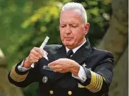  ?? Mandel Ngan / AFP via Getty Images ?? Health and Human Services official Adm. Brett Giroir demonstrat­es the use of a rapid COVID-19 test Monday in the Rose Garden of theWhite House.