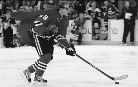  ?? Christian Petersen, Gety Images ?? Chicago Blackhawks forward Patrick Kane, wearing his Superman cape and Clark Kent glasses, of Team Chara gets ready to face St. Louis Blues goalie Brian Elliott of Team Alfredsson in the Breakaway Challenge in Ottawa on Saturday.