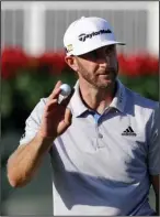  ??  ?? FAST START: Dustin Johnson acknowledg­es the applause of the crowd after sinking a putt on the 18th hole for a 4-under 66 and a share of the firstround lead in the Tour Championsh­ip Thursday at East Lake in Atlanta. Two other players matched Johnson’s...