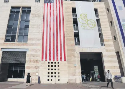  ?? Picture: AFP ?? POLITICAL PALS. The US flag hangs at the entrance of a Jerusalem Municipali­ty building following US President Donald Trump’s decision on Wednesday to recognise the city as the capital of Israel.