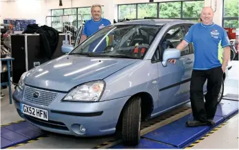  ??  ?? Paul May (on the driver’s side) and Paul Buckman (foreground) look after Suzuki GB’S vehicle fleet, including more than 50 press cars. They maintained the Lianas before, during and after filming with the F1 drivers. The vehicle here is Car Two, wearing...