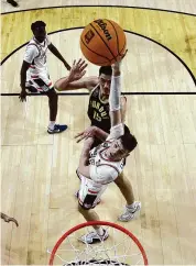  ?? Brett Wilhelm/NCAA Photos via Getty Images ?? Donovan Clingan of the Connecticu­t Huskies shoots the ball, defended by Zach Edey of the Purdue Boilermake­rs during a game at State Farm Stadium on Monday in Glendale, Arizona.