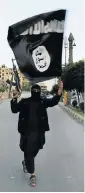  ??  ?? FLAG OF FURY: A militant of the Islamic State waves the group’s flag in Raqqa, Syria. The group has released a slick propaganda video to lure recruits