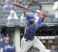  ?? BILL KOSTROUN — THE ASSOCIATED PRESS ?? As rain falls, Texas Rangers’ Jurickson Profar strikes out to end the baseball game against the New York Yankees Saturday at Yankee Stadium in New York.