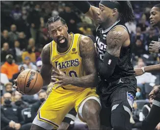  ?? Randall Benton Associated Press ?? DeANDRE JORDAN of the Lakers is guarded by Sacramento Kings center Richaun Holmes during the first quarter at Golden1 Center. The Lakers defeated the Kings 117-92.
