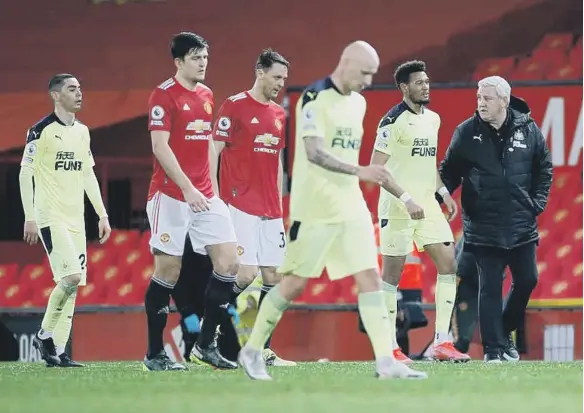  ??  ?? Newcastle head coach Steve Bruce, right, at the final whistle at Old Trafford.