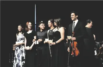  ?? BURNS PHOTO SHARON ?? All of the guest “Young Artist” music students stand on stage to receive IVSA scholarshi­p at the end of the Imperial Valley Symphony Young Artist Concert at the Jimmie Cannon Theater for Performing Arts at Southwest, on Saturday, June 3, in El Centro.