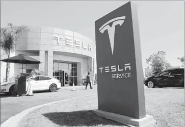  ?? Allen J. Schaben Los Angeles Times ?? TESLA’S PUSH to ramp up production may be overwhelmi­ng its service resources. Despite customer complaints of extended wait times for delivery status or repairs, Tesla points to high marks in Consumer Reports.