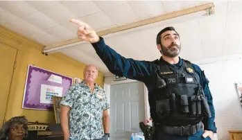  ?? BILLY SCHUERMAN/STAFF PHOTOS ?? Sgt. Nick Davison points to possible exits Saturday as he discusses knowing your surroundin­gs. The Virginia Beach Sheriff’s Office conducted active shooter training at Asbury Christian Fellowship Church in Pungo.