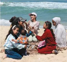  ?? — AFP ?? Joy amid chaos: Palestinia­n girls playing at the beach in Rafah.